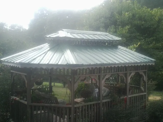 Two tier green metal roof on a garden gazebo in Kramer