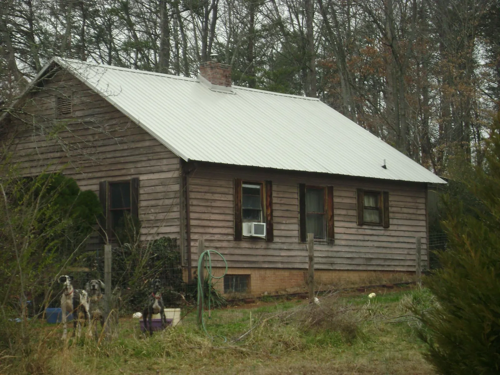 White metal roof on an old wood sided farmhouse, from a Asphalt Shingle Roof Repair job in Kramer